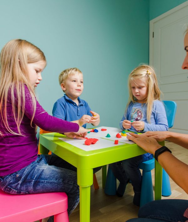 children-sit-desks-kindergarten-sculpt-various-figures-use-plasticine The children sit at the desks in the kindergarten and sculpt various figures use plasticine