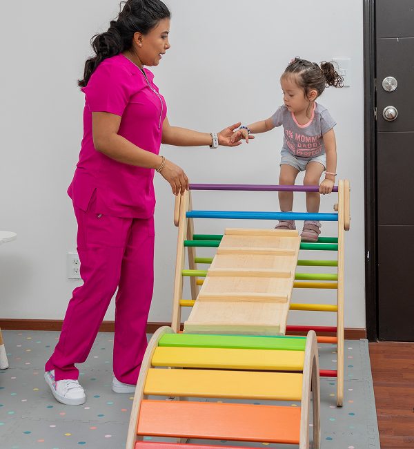 pediatrician-helps-girl-climb-wooden-game-that-he-has-his-office 1 pediatrician-helps-girl-climb-wooden-game-that-he-has-his-office 1