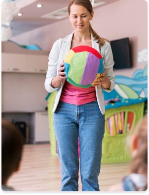 teacher-holding-colorful-ball teacher-holding-colorful-ball